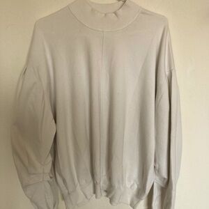 Free People cozy oversized turtleneck sweatshirt with ruffle detail on sleeve
